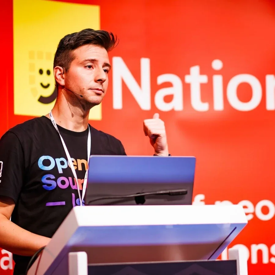 A developer on stage presenting at a conference