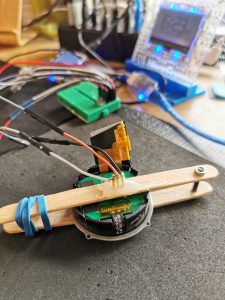 a smartwatch component with wires connected