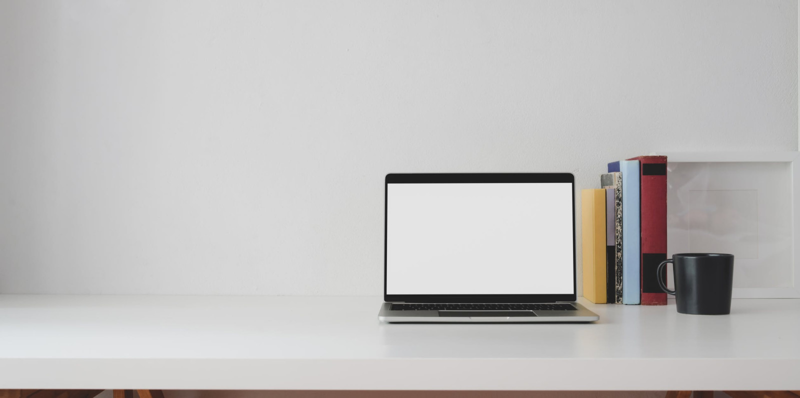 a picture of a laptop on a clean desk to symbolize a WFH Conference