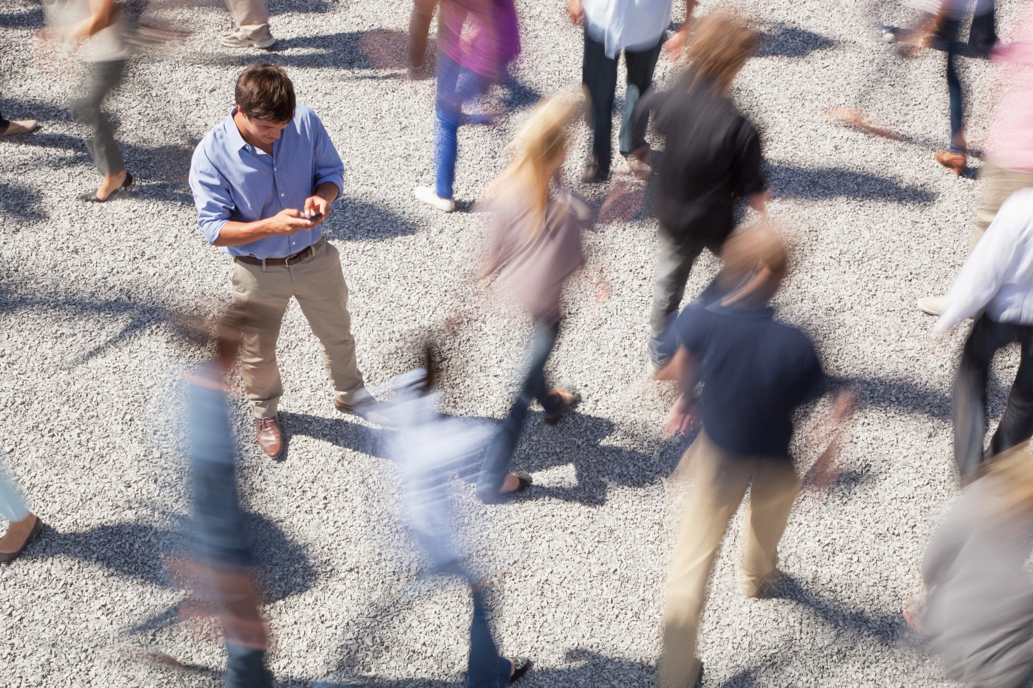 Health Service Executive - A man using his phone among a crowd